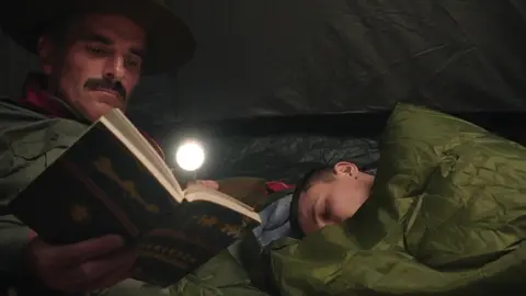 A Scout And His Scoutmaster Being Sneaky In The Tent